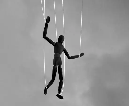 Losing control. Image shows wooden puppet on a string