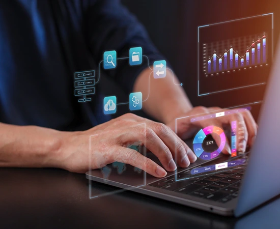 Person working on a laptop with virtual data analytics and cloud computing graphics overlayed